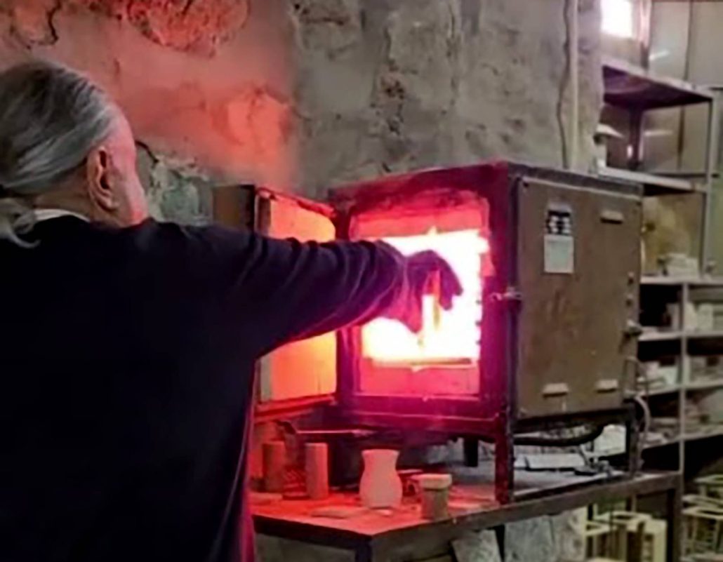 Neshan Balian loading hand-painted reproduction tiles into the kiln for firing