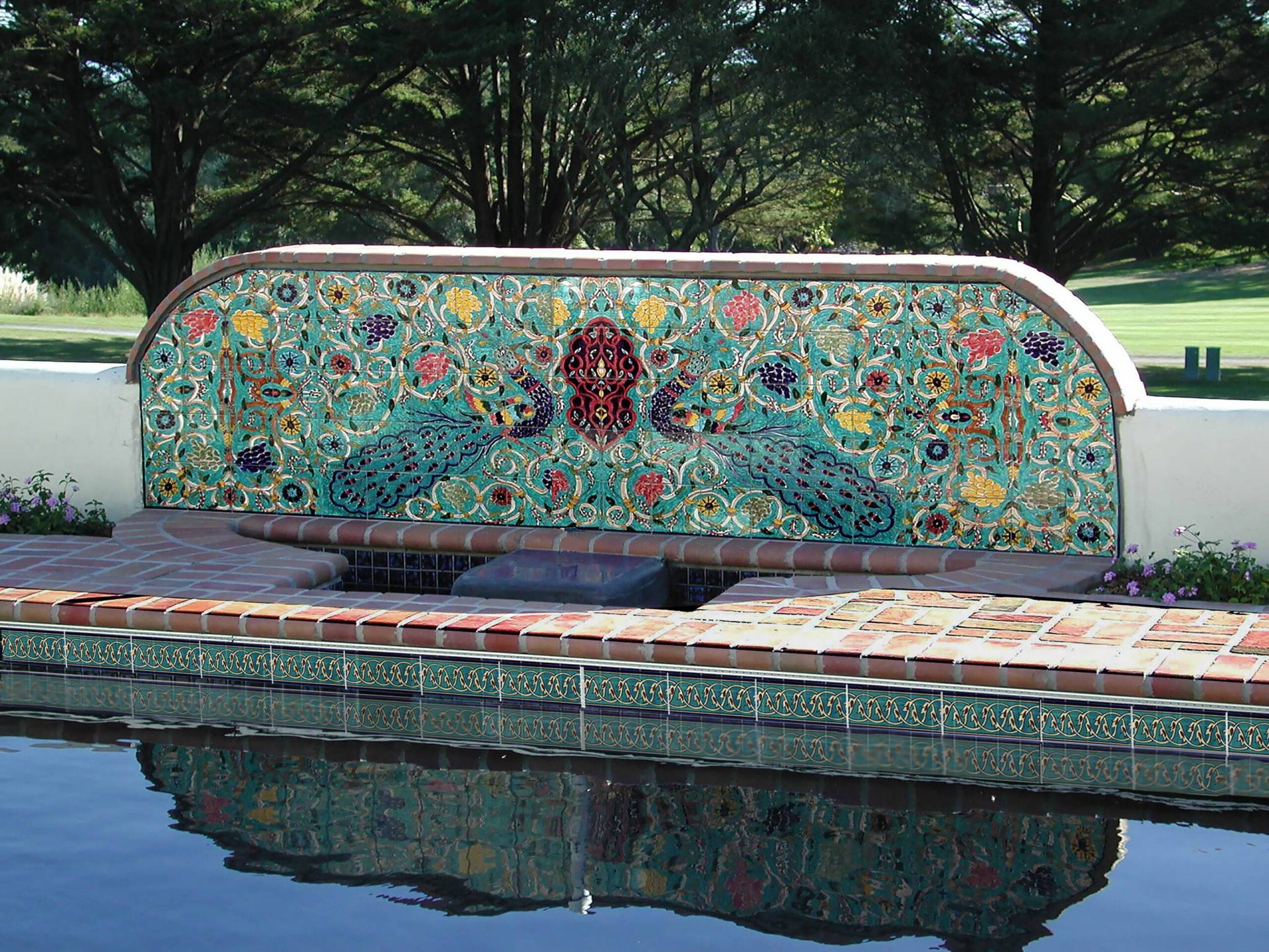 Mirror Peacock tile mural by the pool