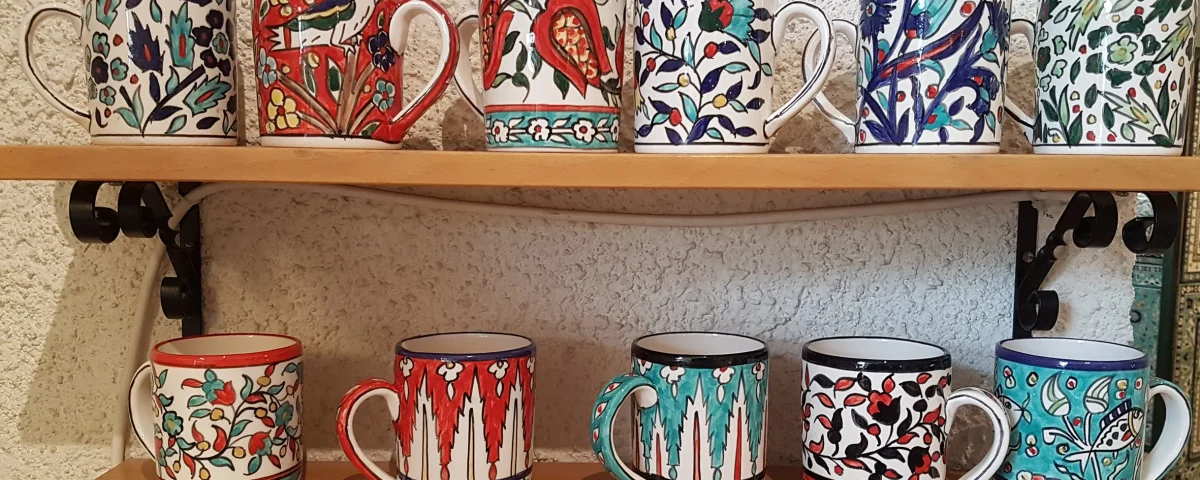 Hand-painted Balinese pottery mugs with floral and animal patterns