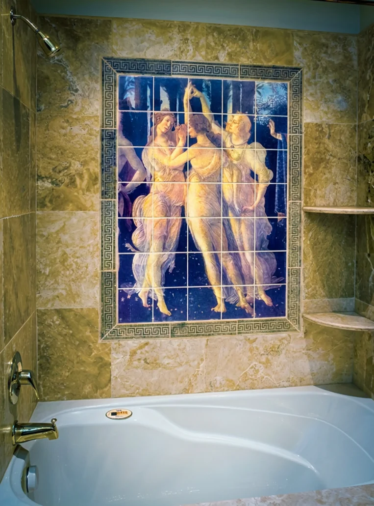 A hand-decorated ceramic tile mural in the shower section of a bathroom