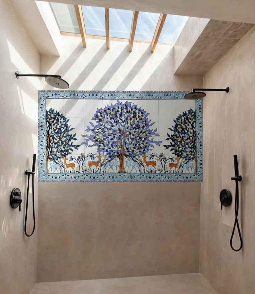 Hand-painted ceramic tile mural of a Lilac Tree of Life with deer, installed in a modern bathroom shower