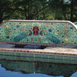 A ceramic tile mural with porcelain tiles by a pool with Balian waterline pool tiles