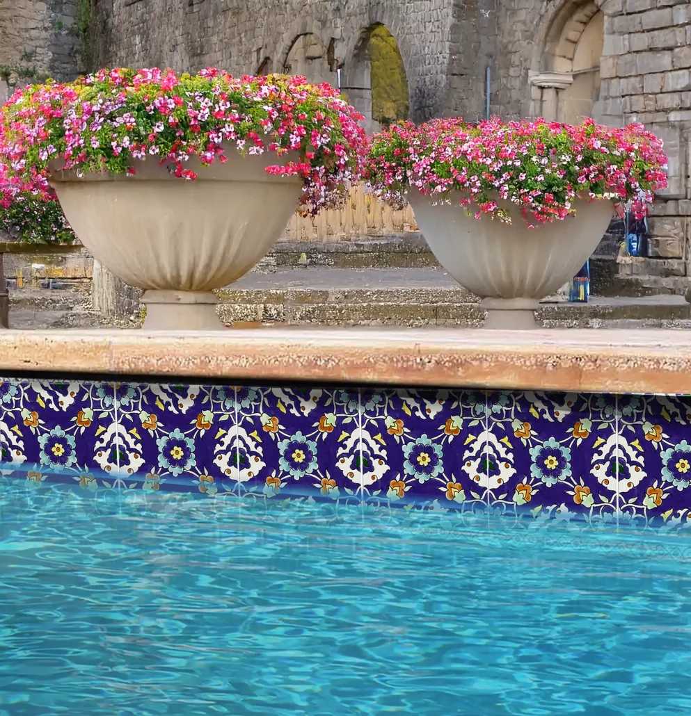 Dark blue hand-painted Mediterranean pool tiles arranged as a waterline layout