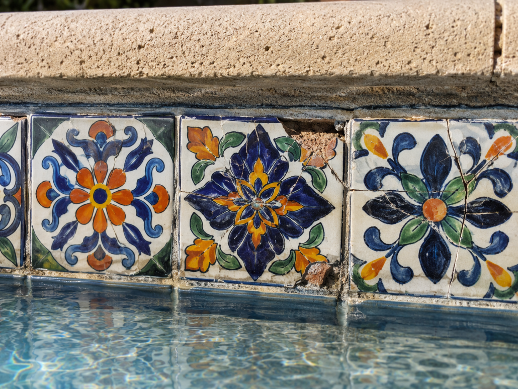 Cracked and crazed Talavera earthenware tile showing why low-fired tile fails at the pool waterline